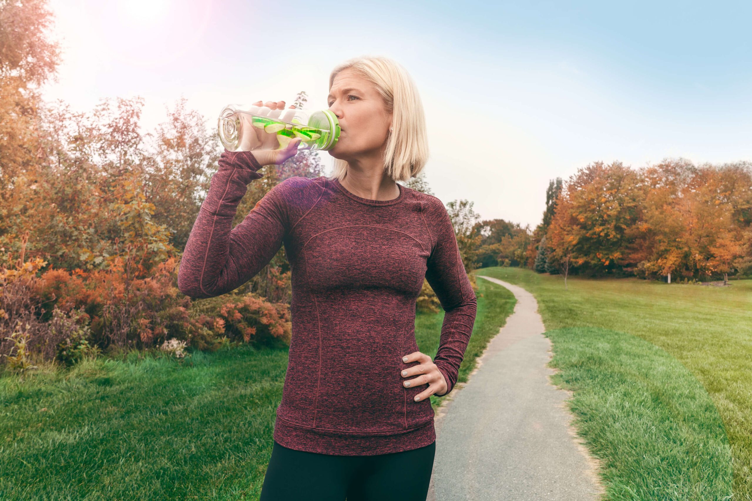 Runner drinking cucumber water